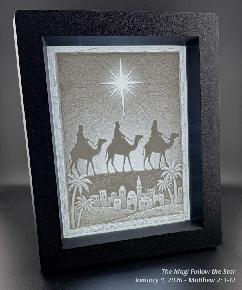 Decorative backlit picture frame art with three wise men on camels and a star, framed in black.